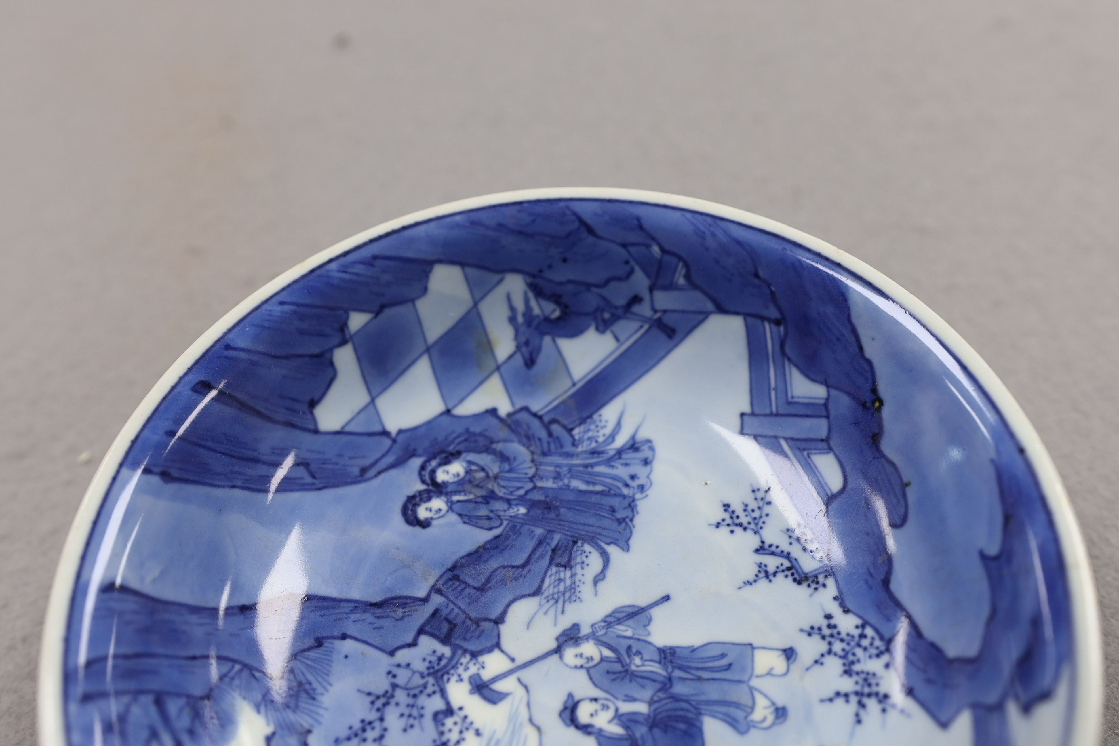 NB BOTH WITH HAIRLINE CRACKS A pair of Chinese blue and white small dishes, Kangxi six character marks and of the period (1662-1722), 15.7cm and 15.8cm diameter, foot later pierced, hairline cracks